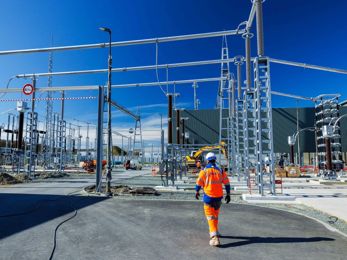 High-voltage transmission infrastructure against an evening sky, evoking cross-border energy interconnection