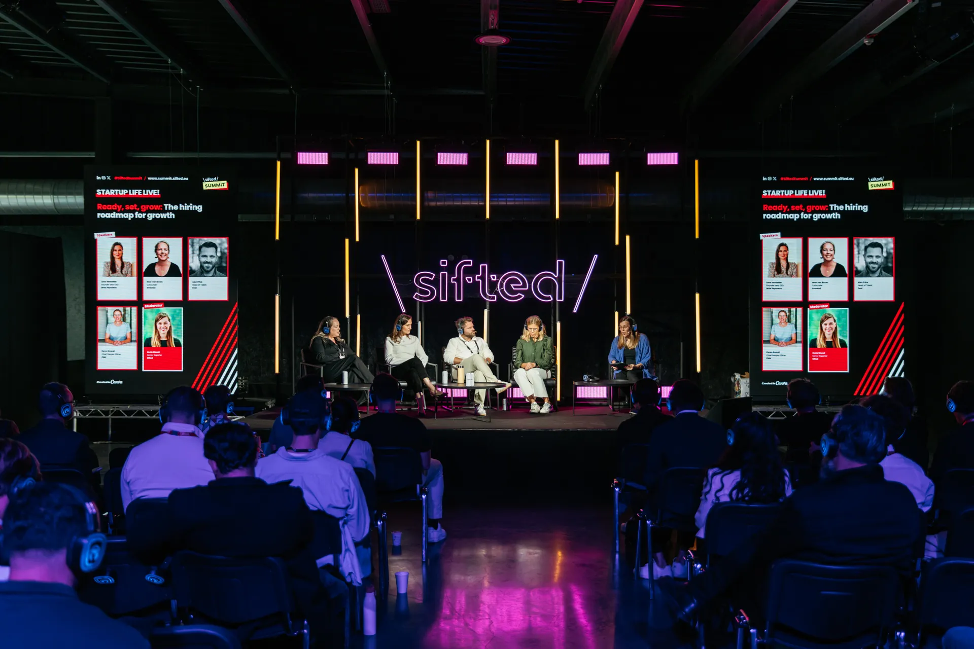 A panel discussion at a summit titled "sifted" features five speakers seated on stage in front of a large neon "sifted" sign, with two screens displaying profil